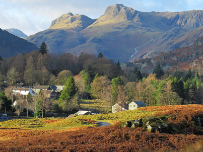Cottage extensions on Elterwater common dwarfed by the Langdale Pikes