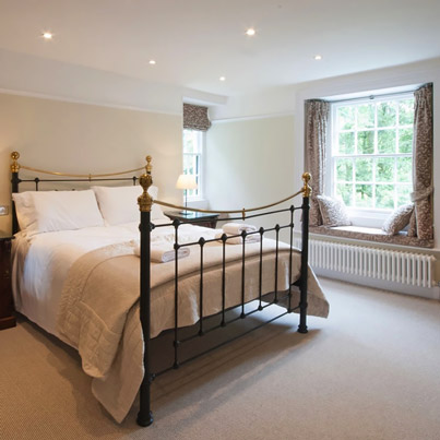 Listed Cottage after renovation view of bedroom with window seats - Click for larger image